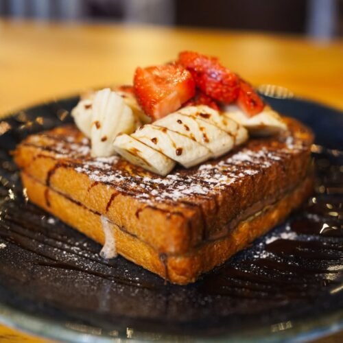 Sweeten your day! 🍓 Dive into our delectable French toast, topped with fresh bananas and strawb